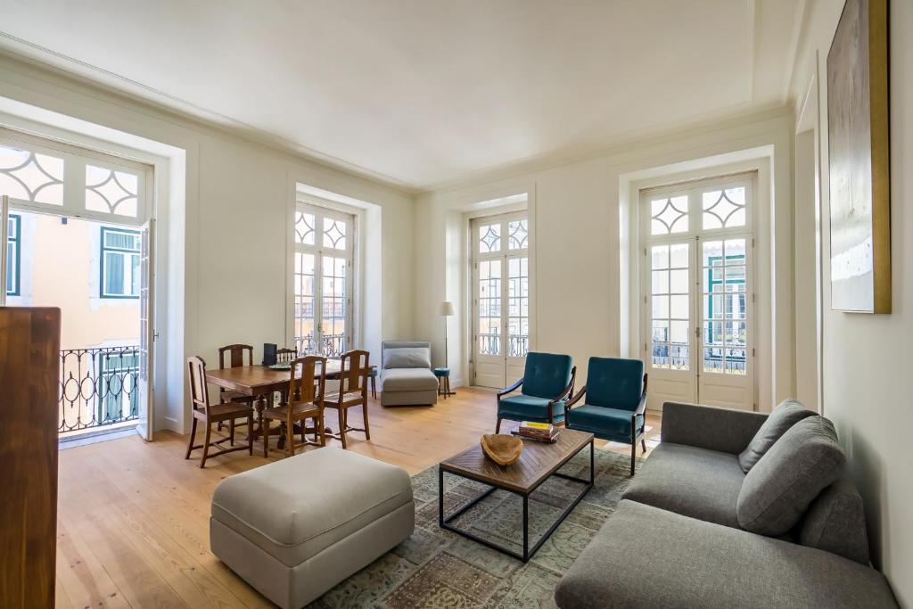 a living room with a couch and chairs and a table at Santa Justa Prime Guesthouse in Lisbon