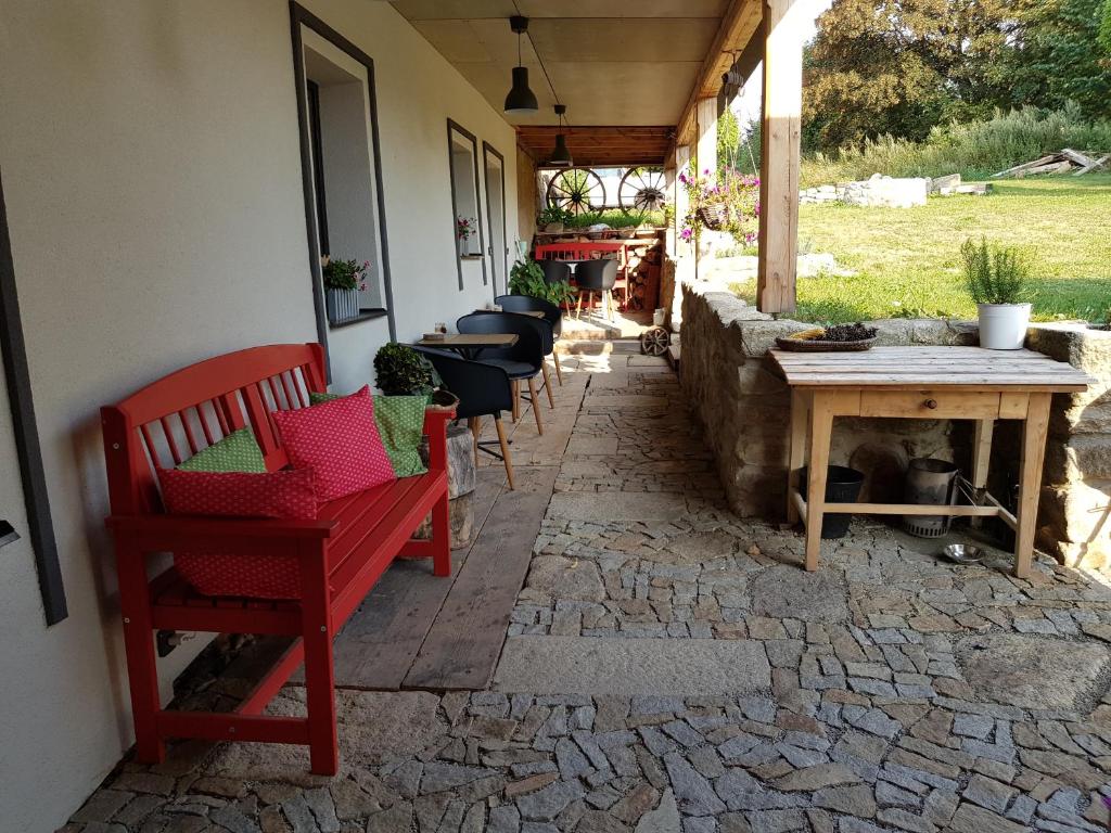 a patio with chairs and a table on a stone floor at Penzion Only in Kunějov