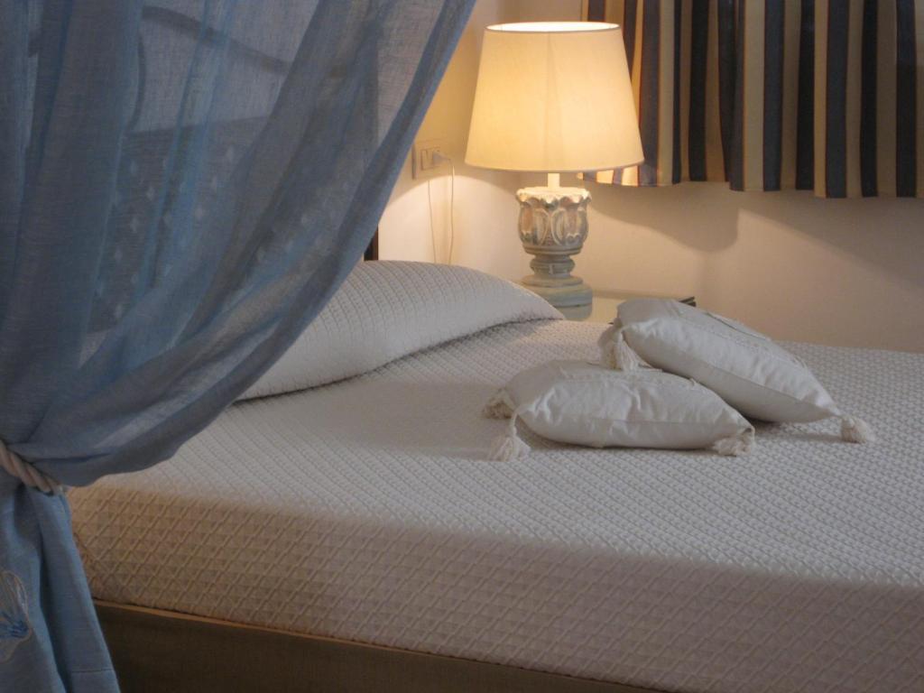 Postel nebo postele na pokoji v ubytování Hotel Monti Di Mola