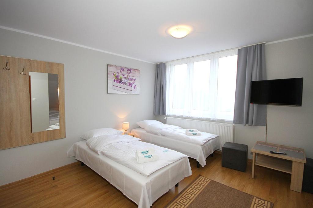 Posteľ alebo postele v izbe v ubytovaní Apartamenty Olsztyn