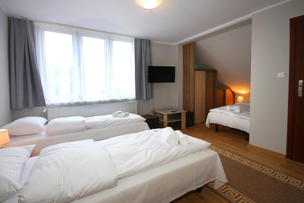 Posteľ alebo postele v izbe v ubytovaní Apartamenty Olsztyn