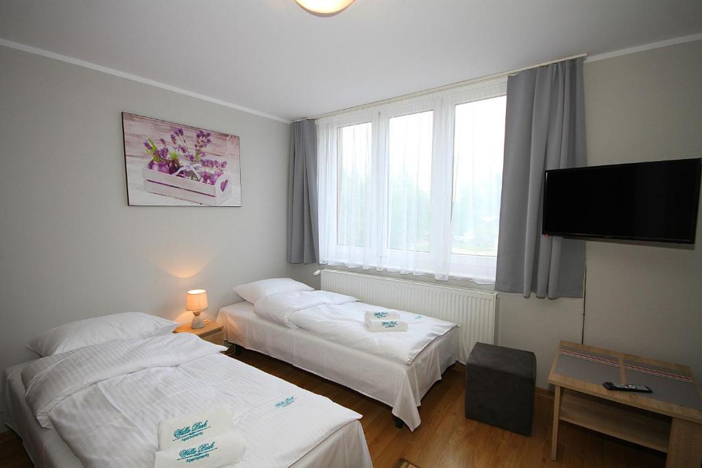 Posteľ alebo postele v izbe v ubytovaní Apartamenty Olsztyn