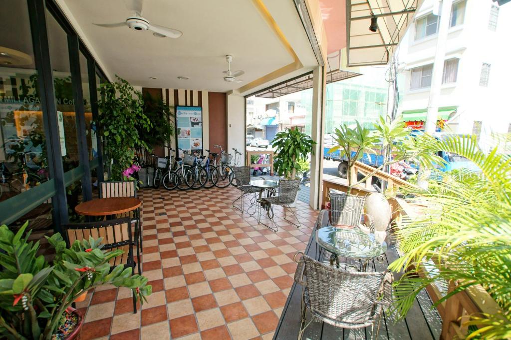 a restaurant with tables and chairs and plants in a room at Taitung Venice B&B in Taitung City