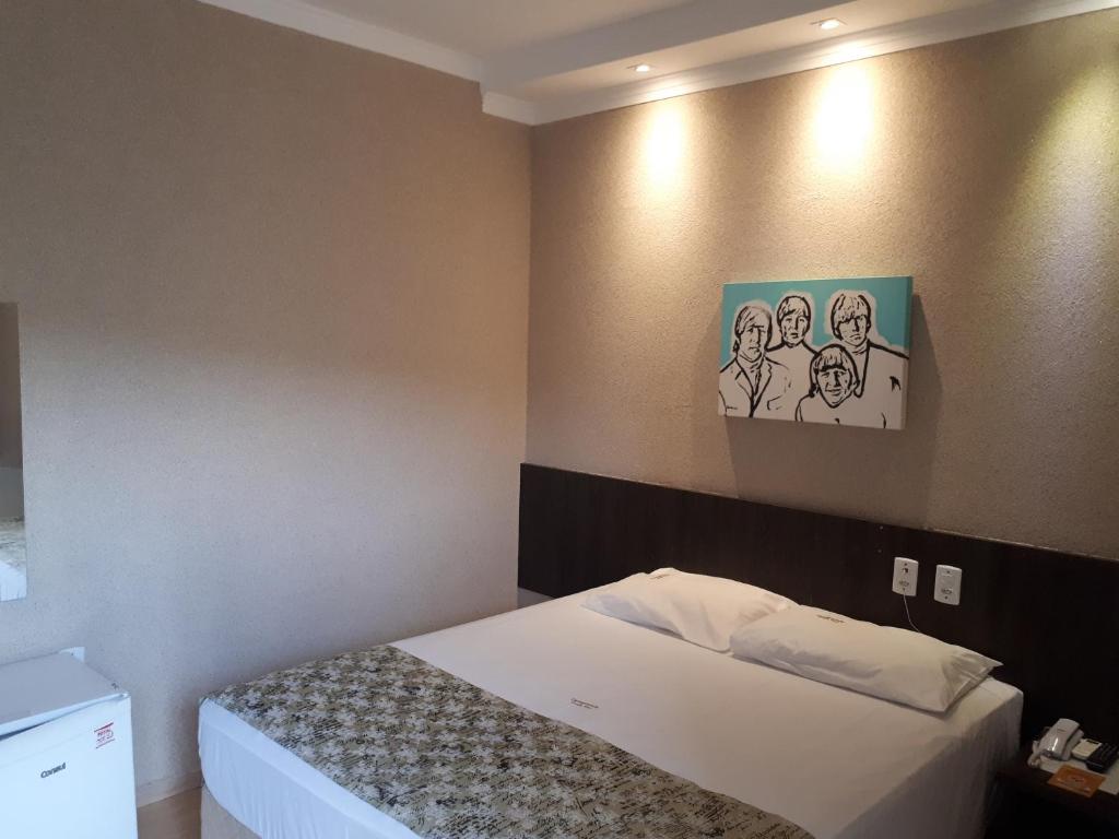 En eller flere senge i et værelse på Casagrande Olímpia Hotel