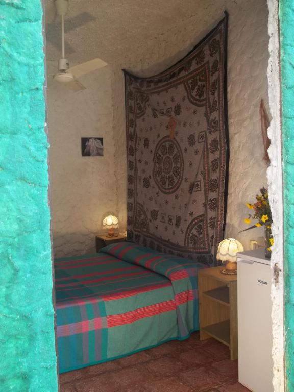 A bed or beds in a room at I Dammusi del Blu Green