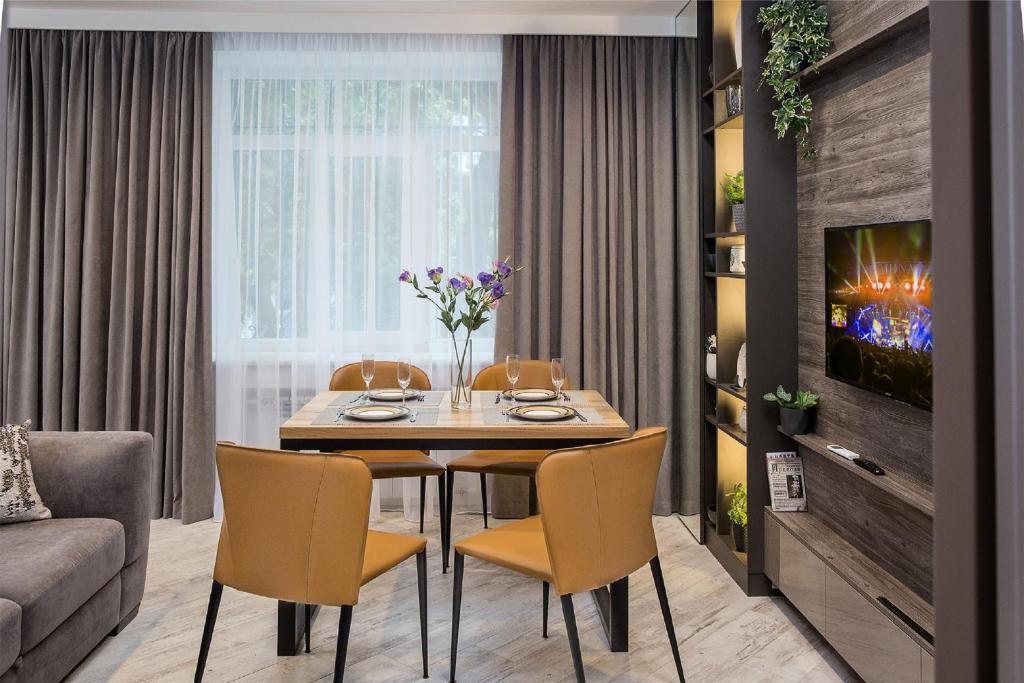 a dining room with a table and chairs at City Garden Apartments in Odesa