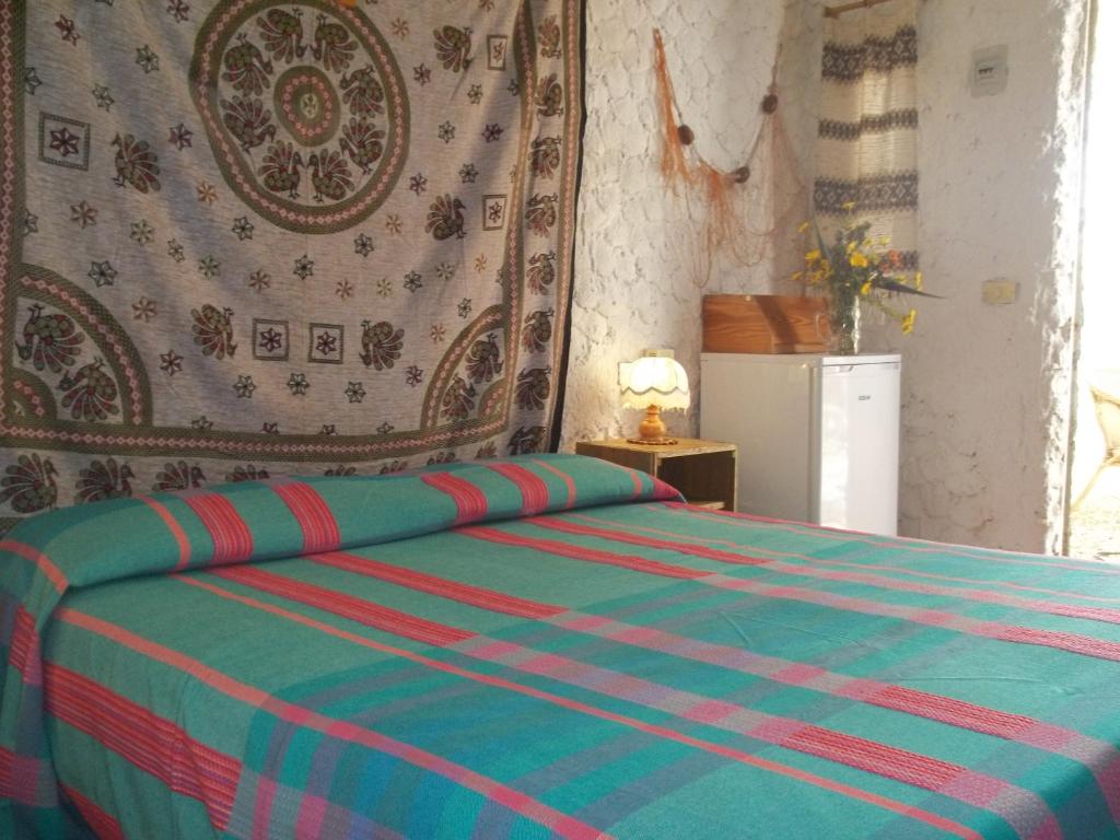 A bed or beds in a room at I Dammusi del Blu Green