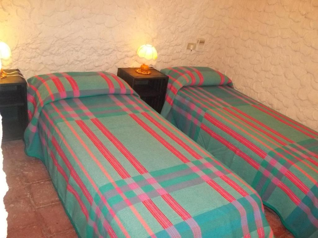 A bed or beds in a room at I Dammusi del Blu Green