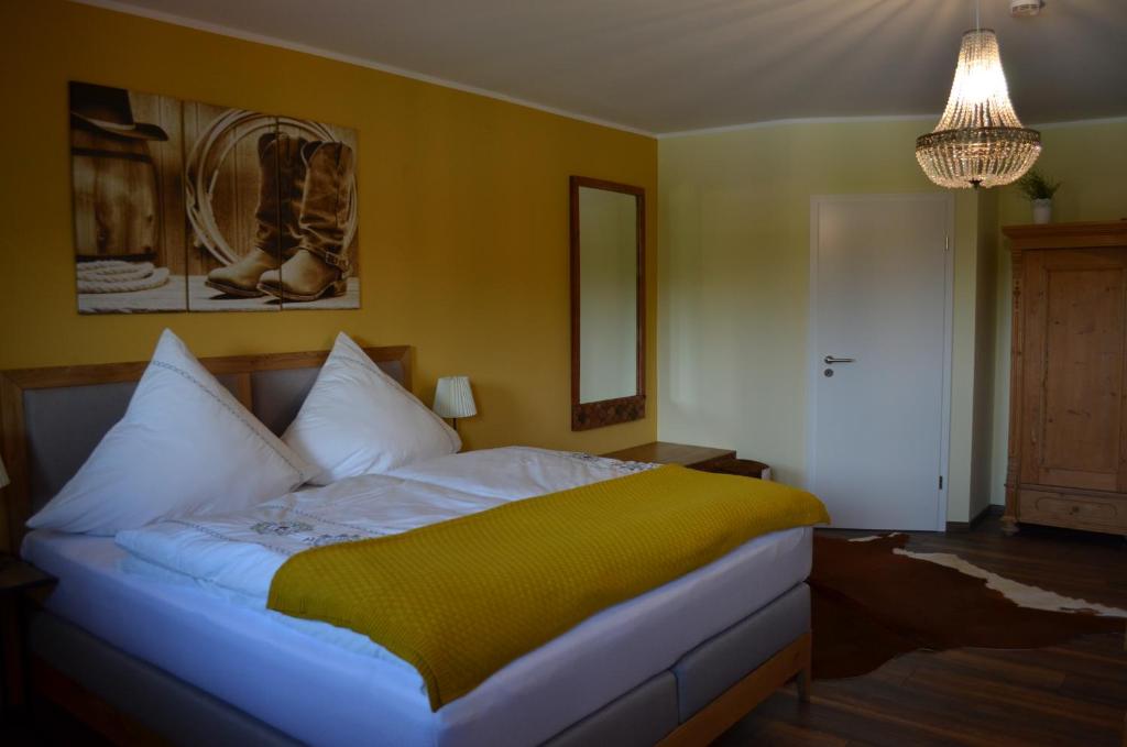 a bedroom with a bed with a yellow wall at Fewo Calico in Eging
