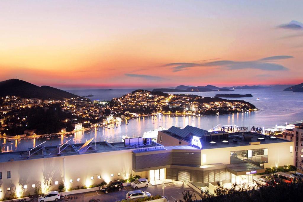 a view of a marina at night at Hotel Adria in Dubrovnik
