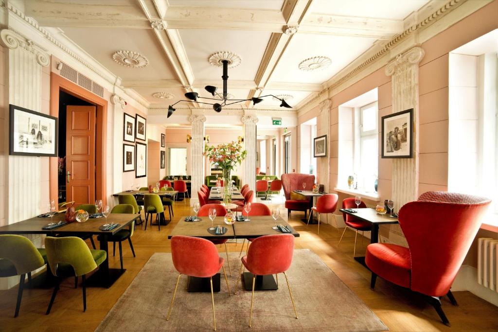 a restaurant with tables and chairs in a room at H15 Boutique Hotel, Warsaw, a Member of Design Hotels in Warsaw