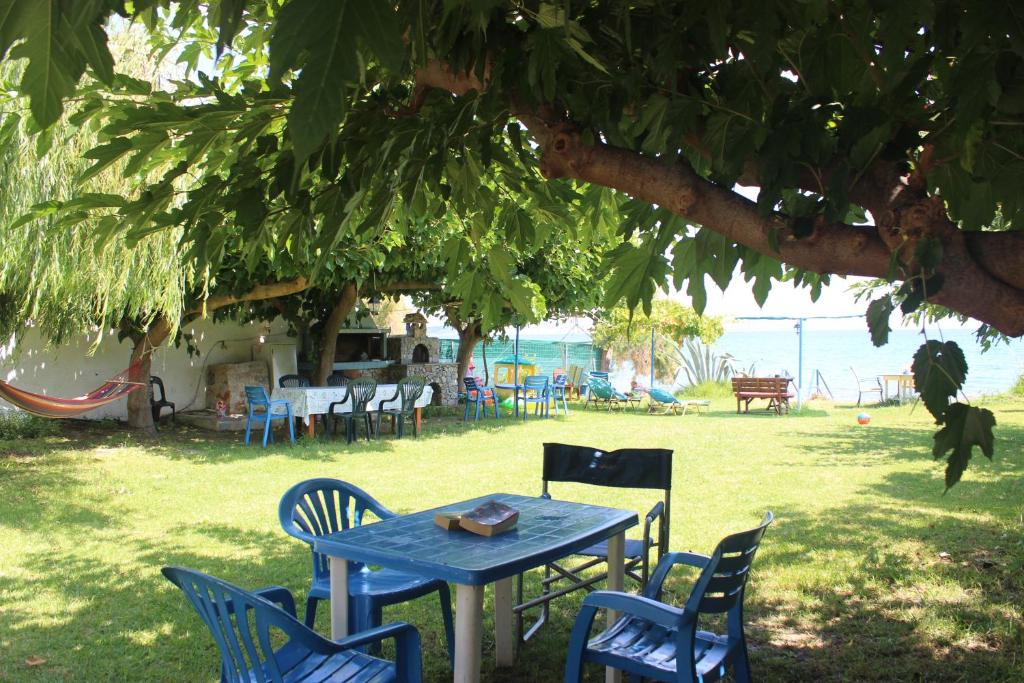 a blue table and chairs under a tree at Maria's Apartments in Kalyves