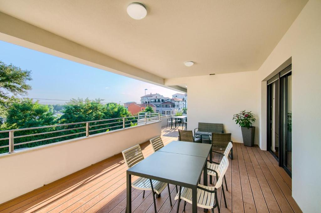 einen Balkon mit einem Tisch und Stühlen sowie Aussicht in der Unterkunft Rooms K&T sea side luxury in Pula