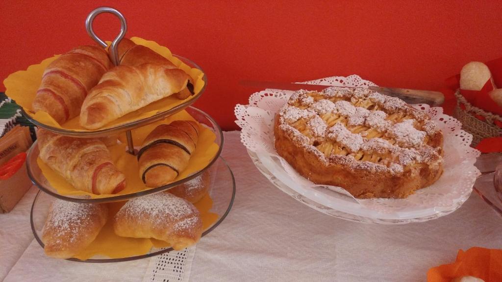 a table with three tiers of bread and pastries at B&B La Terrazza in Mantova