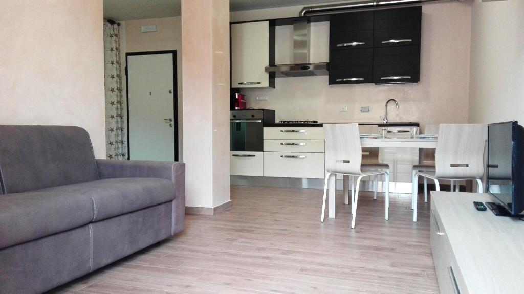 a kitchen and living room with a couch and a table at Gloria House in Levanto