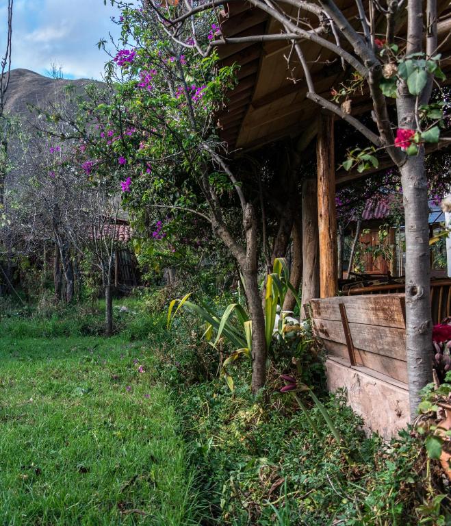 a house with flowers on the side of it at Eco Lodge Los Perales-Urubamba in Urubamba