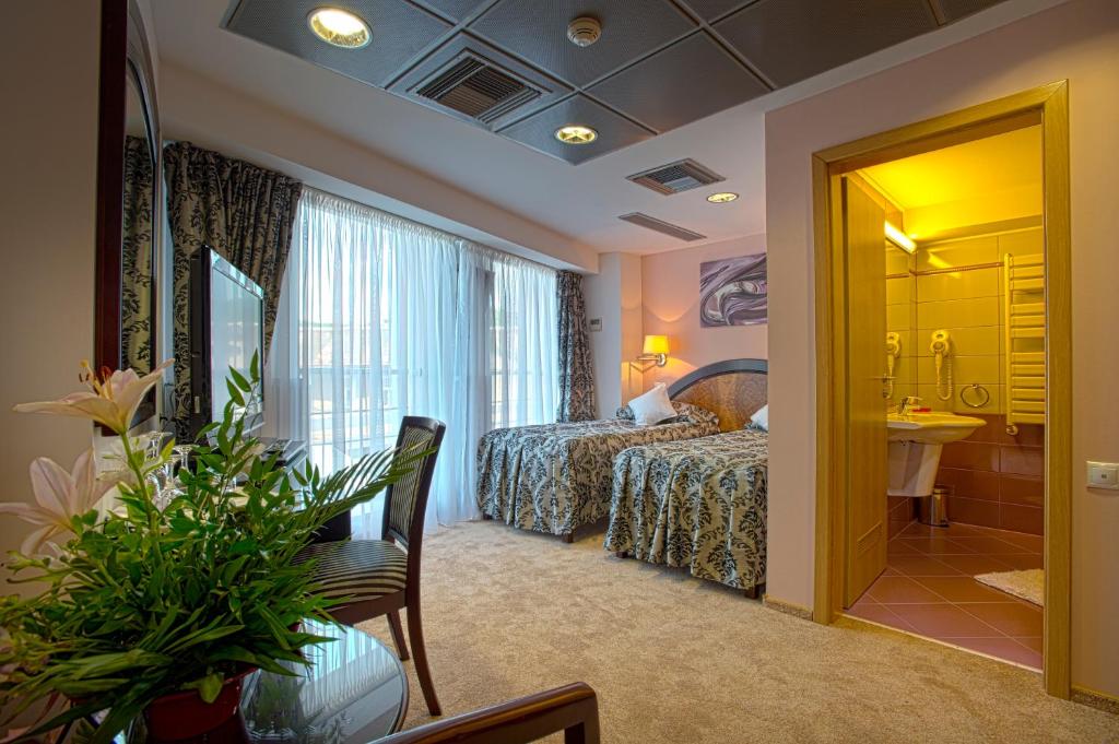 Postel nebo postele na pokoji v ubytování Hotel Ambient