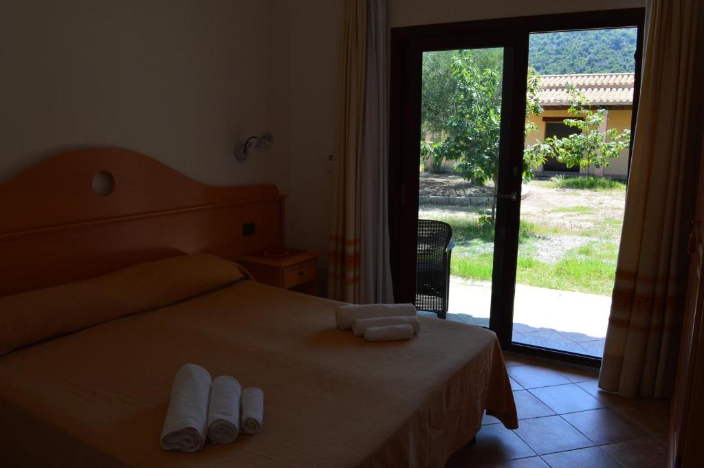Postel nebo postele na pokoji v ubytování Hotel Cardedu