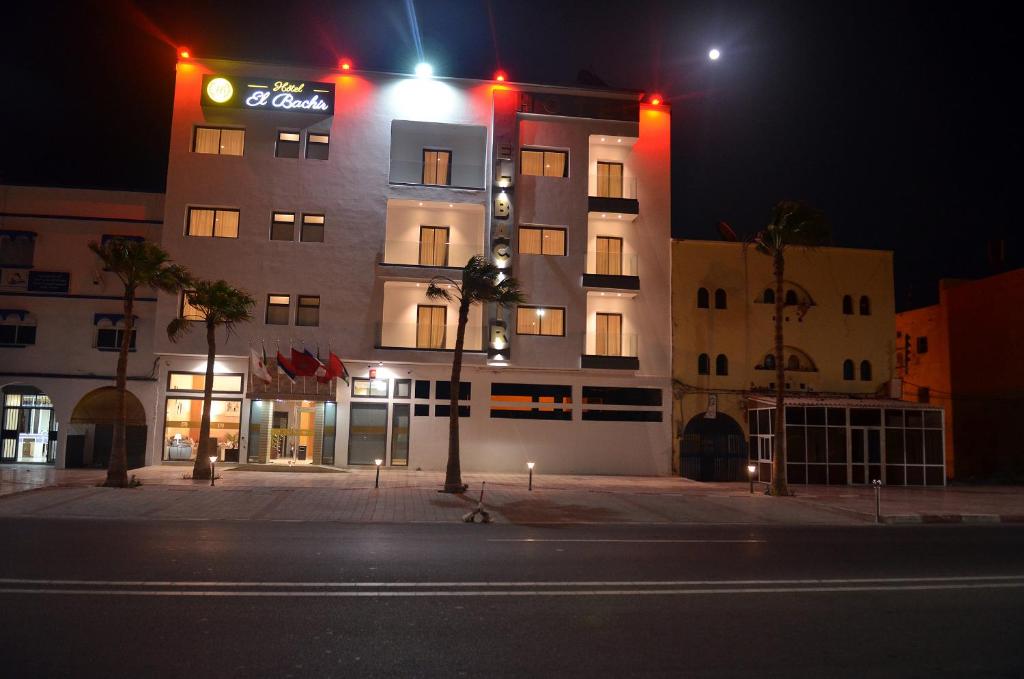 a building with a sign on the side of it at night at Hotel El Bachir in Dakhla