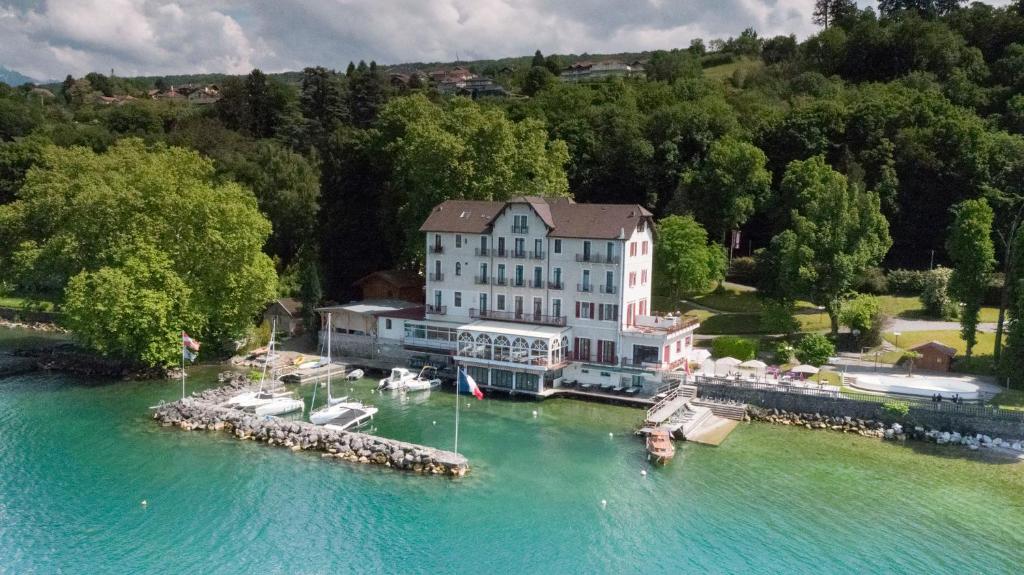 an aerial view of a large building on the water at Hôtel Des Princes in Amphion les Bains