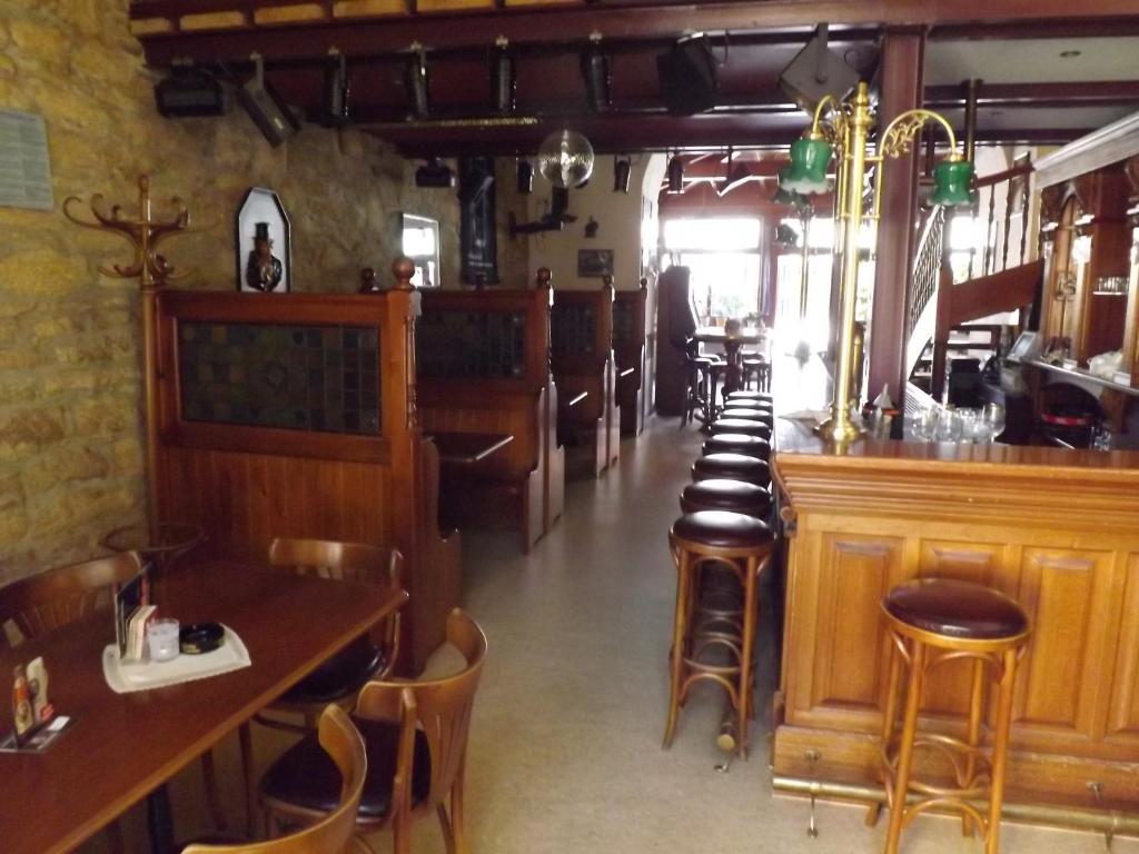 a restaurant with a row of chairs and a bar at Hotel "Zur Sonne" in Querfurt