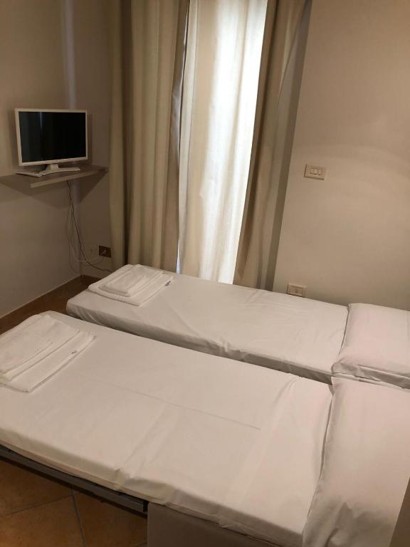 Posteľ alebo postele v izbe v ubytovaní A DUE PASSI temporary apartment