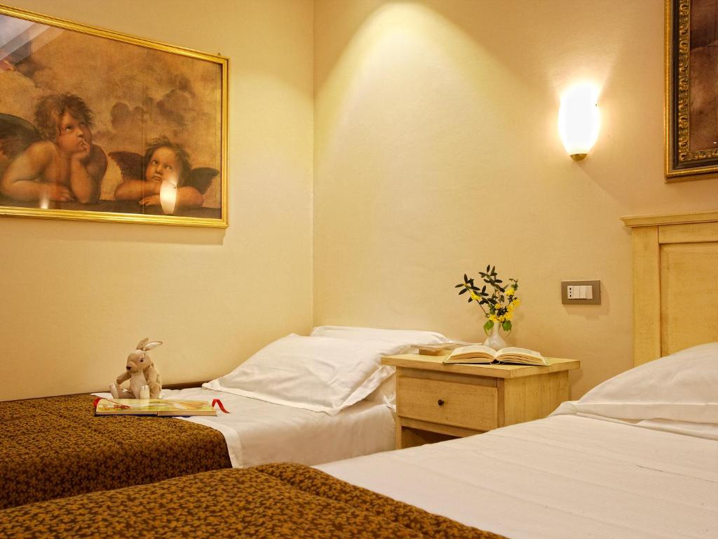 Postel nebo postele na pokoji v ubytování Hotel Porta Nuova