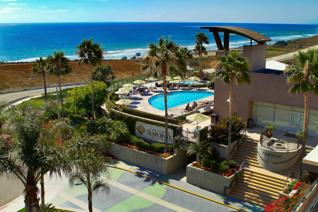 an aerial view of a resort with a swimming pool and the ocean at Carlsbad Seapointe Resort in Carlsbad