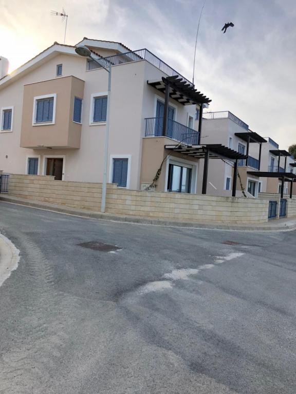 a large white house on the side of a street at Indigo in Protaras