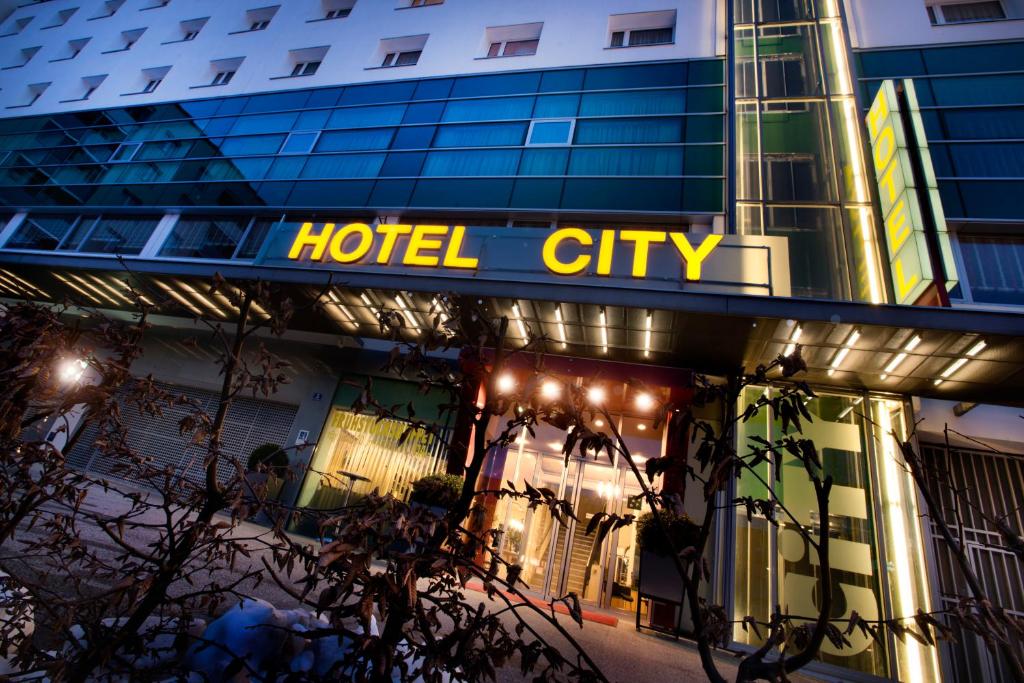 a hotel city sign on the front of a building at Hotel City in Villach