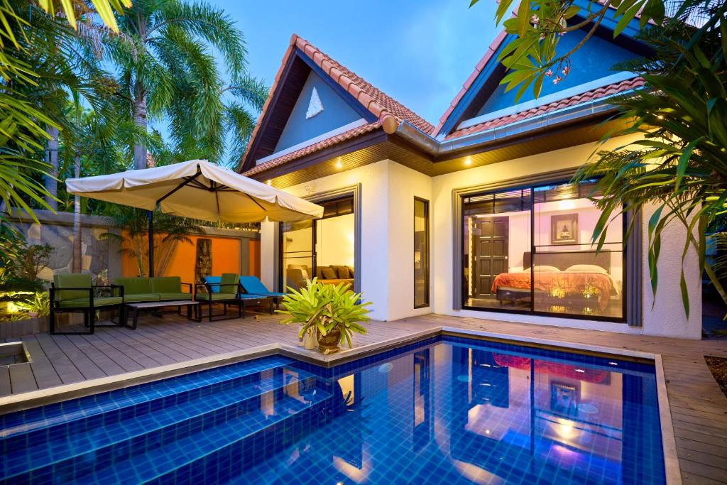 a house with a swimming pool in front of a house at VIEW TALAY VILLAs POOL 60, JOMTIEN BEACH, PATTAYA in Jomtien Beach