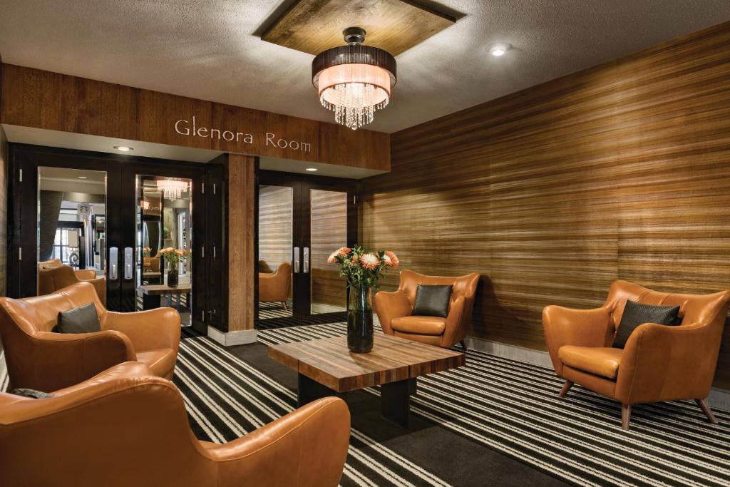 a waiting room with chairs and a table at Coast Edmonton Plaza Hotel by APA in Edmonton