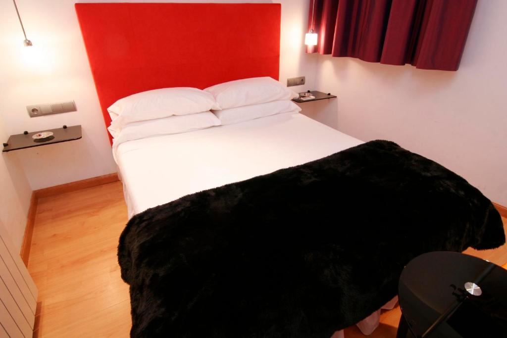 Postel nebo postele na pokoji v ubytování Hostal Santo Domingo