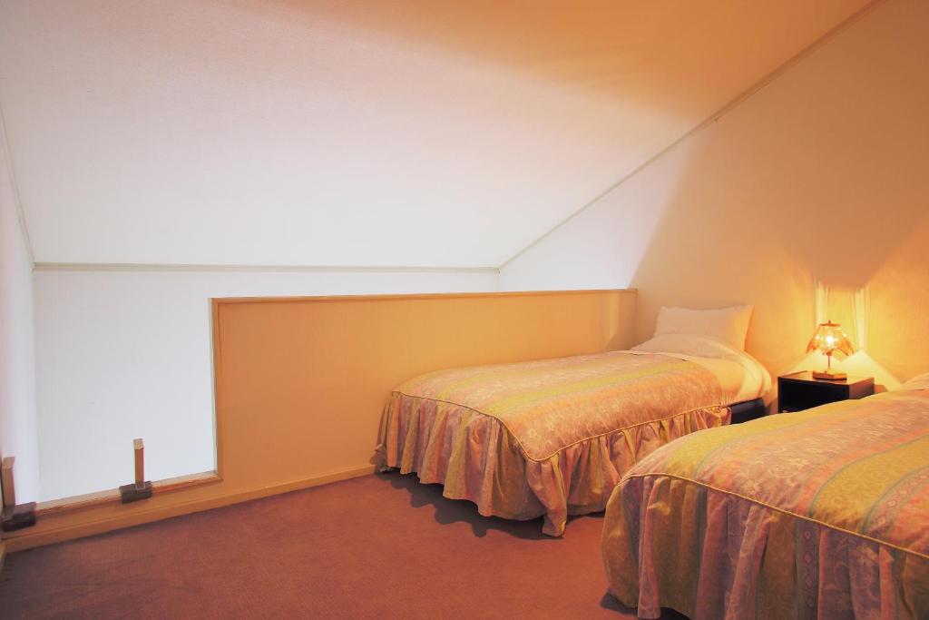 Postel nebo postele na pokoji v ubytování Mt Fuji B&B PENSION LE LAGON