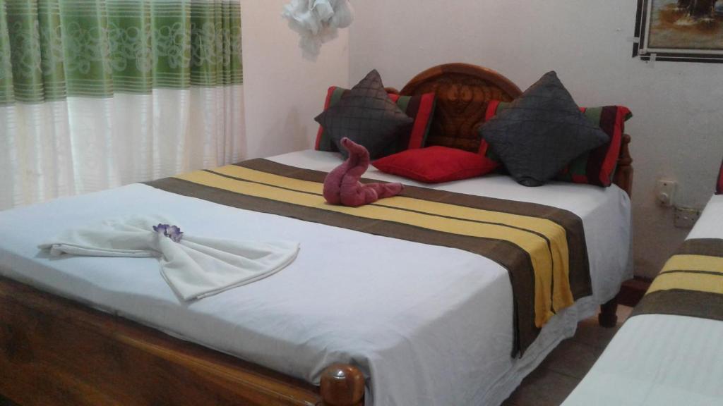 Postel nebo postele na pokoji v ubytování Kalana Homestay