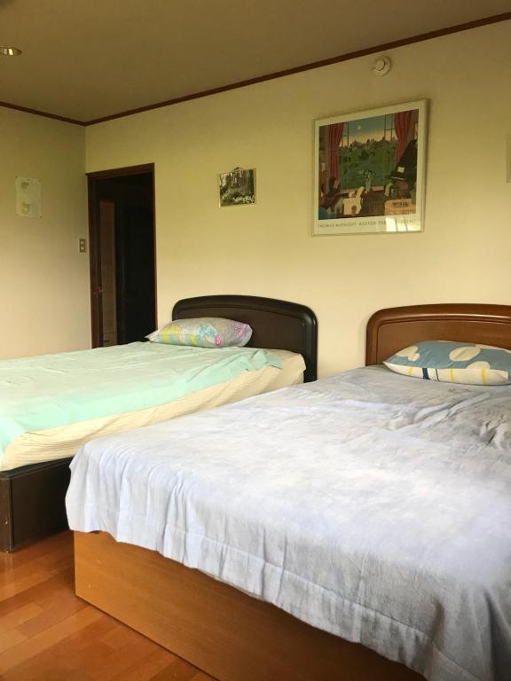 Кровать или кровати в номере Kizuna no Ie