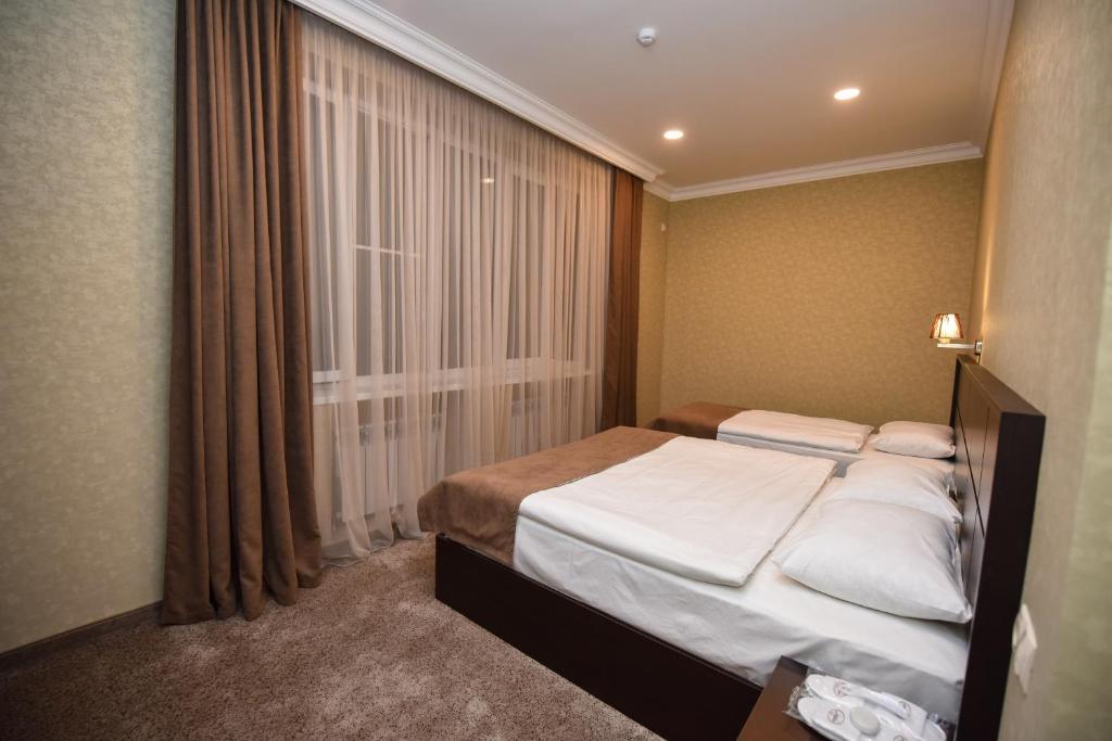 Postel nebo postele na pokoji v ubytování Laguna Hotel