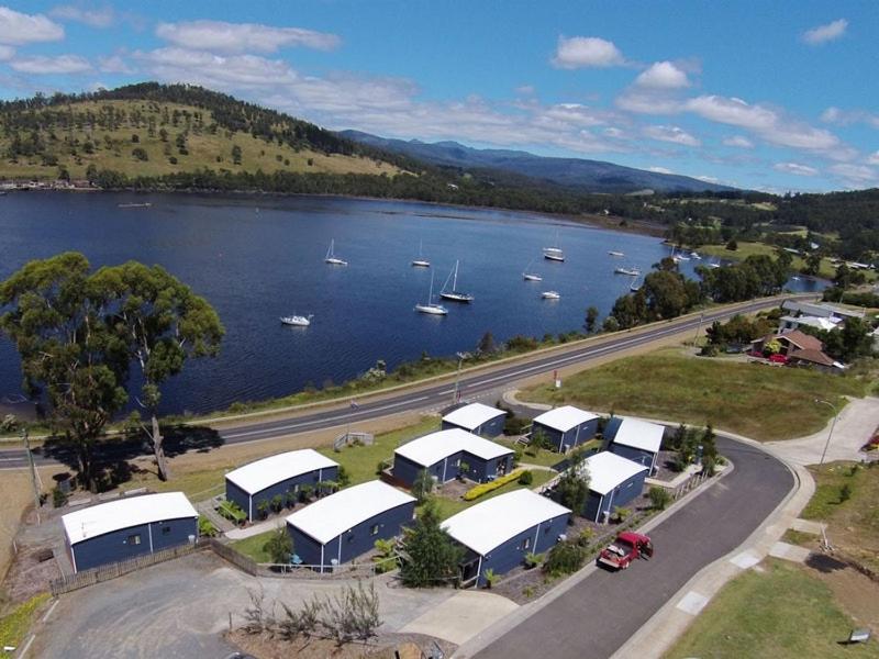 an aerial view of a harbor with boats in the water at Port Huon Cottages in Port Huon