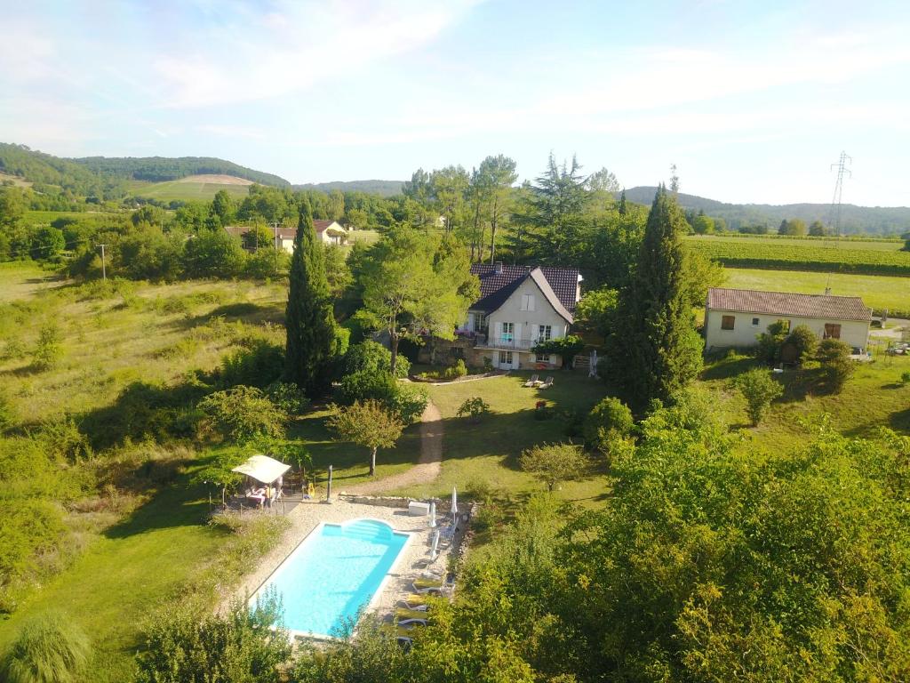 an aerial view of a house and a swimming pool in a field at Chambres d'hôtes Le Verger in Prayssac