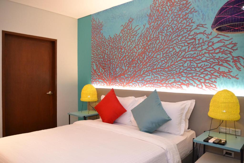 Llit o llits en una habitació de Lagùn Hotel