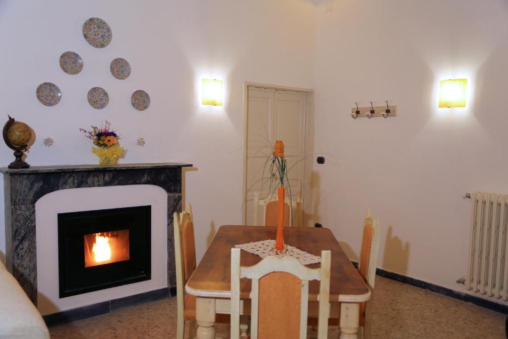 a living room with a table and a fireplace at Casa Francesca Torre Saracena in Dolcedo