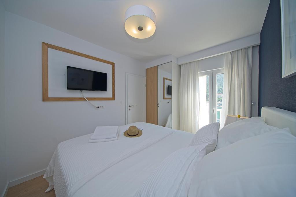 Postel nebo postele na pokoji v ubytování Oyster Paradise Blue Apartment
