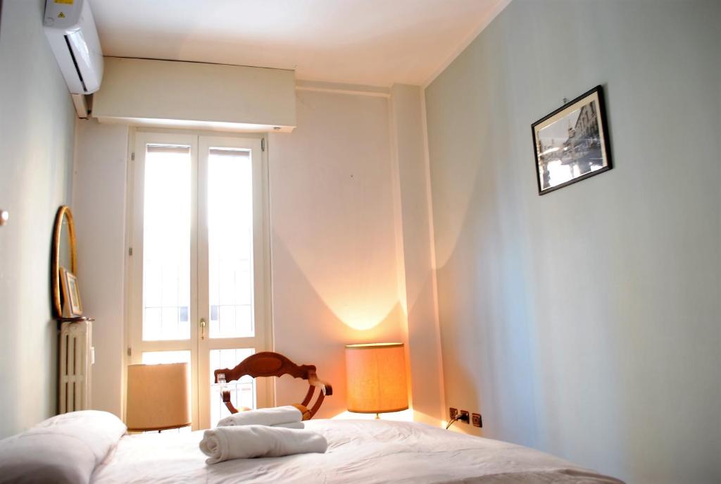 Posteľ alebo postele v izbe v ubytovaní Dreaming Piazza Bra Rooms