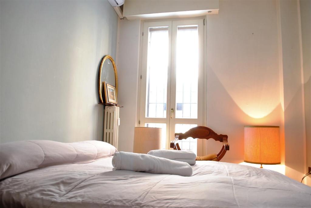 Posteľ alebo postele v izbe v ubytovaní Dreaming Piazza Bra Rooms