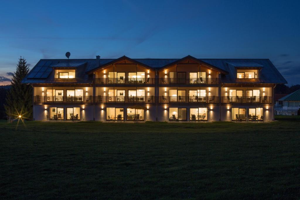 a large house lit up at night at Chalet Alpenrose 134qm am Golfplatz Oberstaufen in Oberstaufen