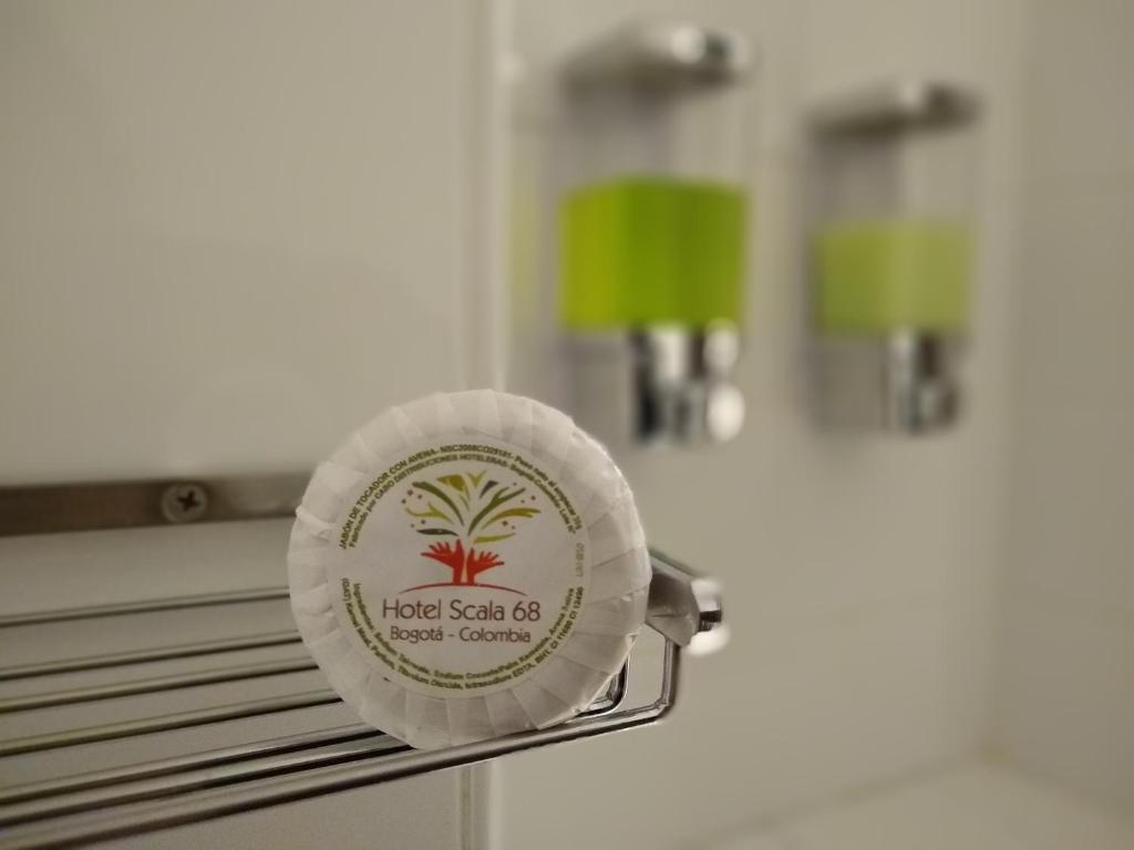 a plate on a towel rack in a bathroom at Scala 68 in Bogotá