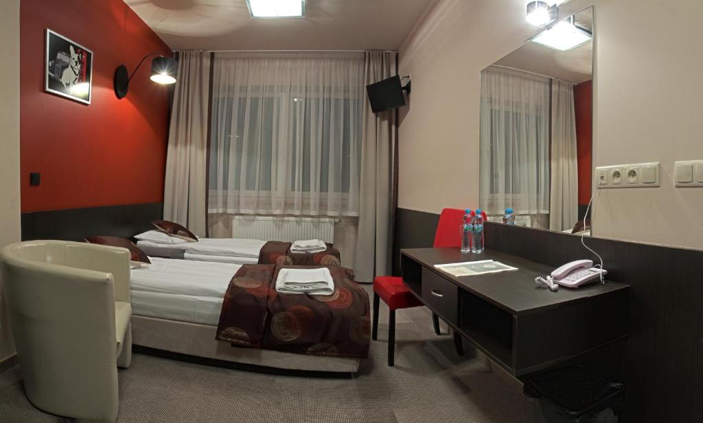 Postel nebo postele na pokoji v ubytování Hotel Ajax