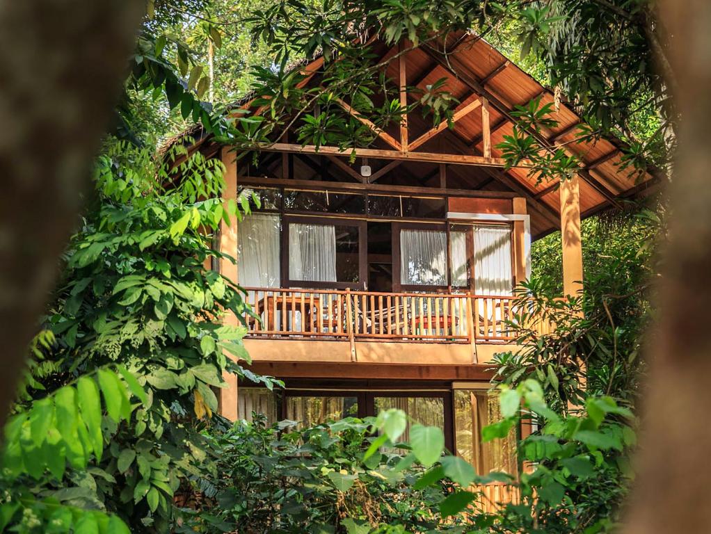 a tree house with a deck in the woods at Jungle Village by Thawthisa in Unawatuna