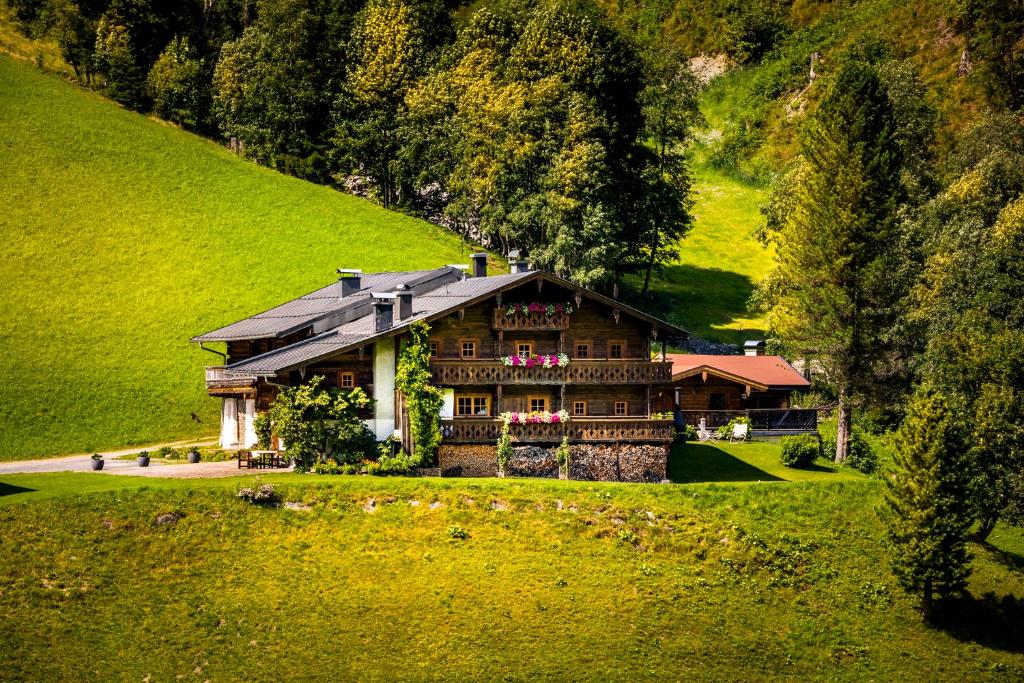 a house in the middle of a green hill at Maroldenhof in Saalbach Hinterglemm