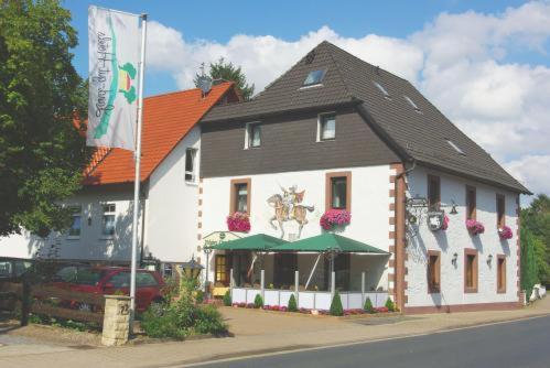 a large building with flowers on the front of it at Land-gut-Hotel Räuber Lippoldskrug in Alfeld